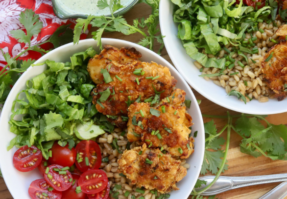 Green Goddess Grain Bowl with Crispy Chicken Thighs, Cherry Tomatoes, Romaine Lettuce, and Whole Grains, served with Creamy Green Goddess Dressing – Healthy and Flavorful Meal Idea