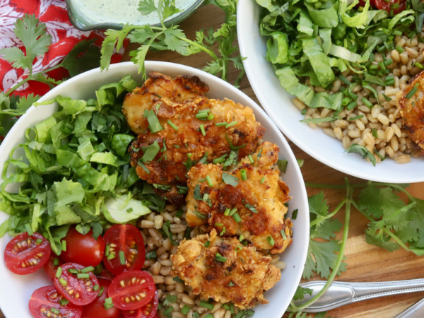 Green Goddess Grain Bowl with Crispy Chicken Thighs, Cherry Tomatoes, Romaine Lettuce, and Whole Grains, served with Creamy Green Goddess Dressing – Healthy and Flavorful Meal Idea