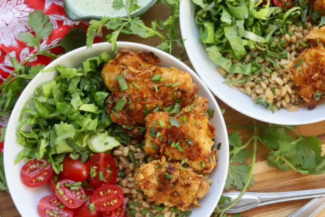 Green Goddess Grain Bowl with Crispy Chicken Thighs, Cherry Tomatoes, Romaine Lettuce, and Whole Grains, served with Creamy Green Goddess Dressing – Healthy and Flavorful Meal Idea