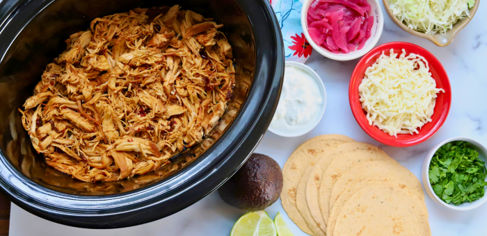 Slow cooker honey chipotle shredded chicken with taco toppings and corn tortillas – spicy chicken meal prep tacos