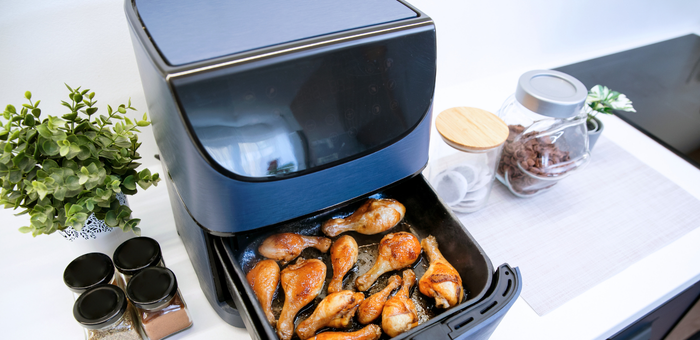 Air fryer cooking seasoned chicken drumsticks for a quick and easy weeknight family dinner