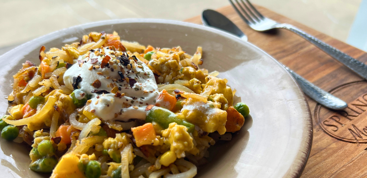 Loaded ground chicken hashbrowns with mixed vegetables, melted cheese, and a dollop of sour cream.