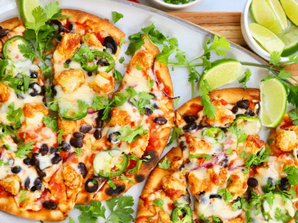 Easy Santa Fe chicken flatbread pizza recipe topped with black beans, jalapeños, melted cheese, and fresh cilantro — a quick and flavorful weeknight dinner.