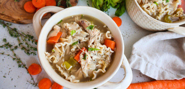 Homemade slow cooker chicken noodle soup with carrots, celery, and egg noodles — cozy and classic comfort food using Springer Mountain Farms chicken.