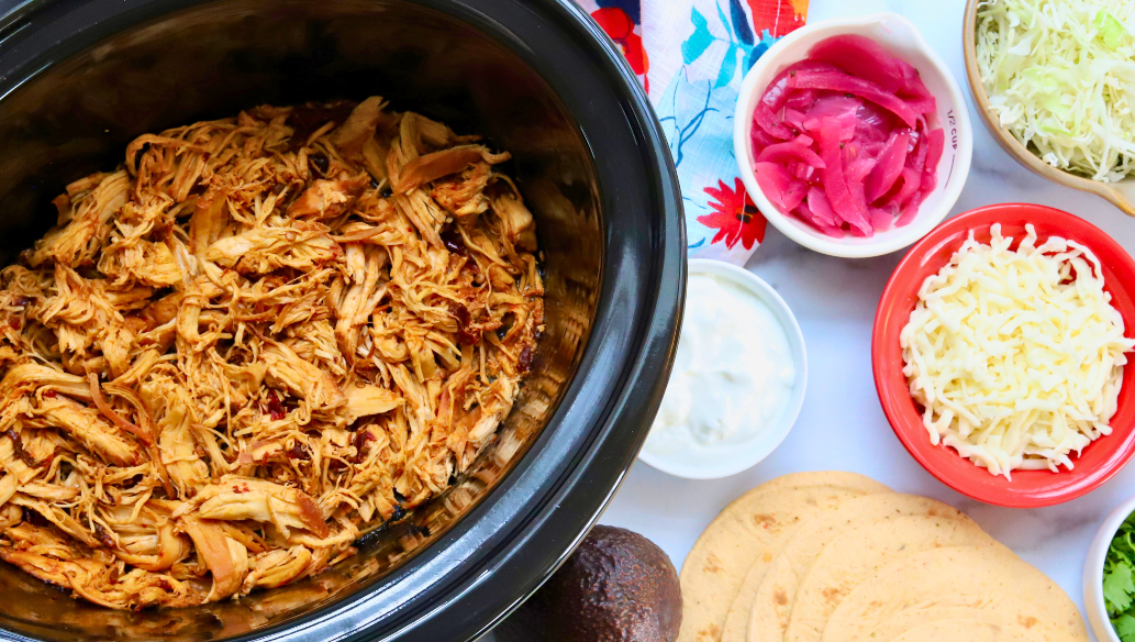 Slow cooker honey chipotle shredded chicken with taco toppings and corn tortillas – spicy chicken meal prep tacos
