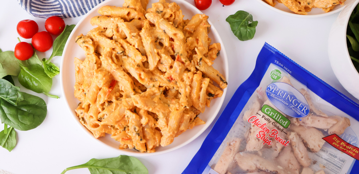 Bowl of creamy pasta made with Springer Mountain Farms grilled chicken strips for a fast, protein-packed dinner.