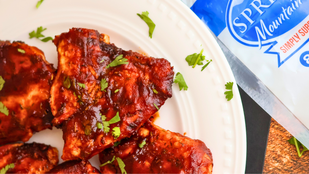 Air Fryer BBQ Chicken Breast made with Springer Mountain Farms Boneless Skinless Chicken Breasts, glazed with barbecue sauce and garnished with fresh parsley.