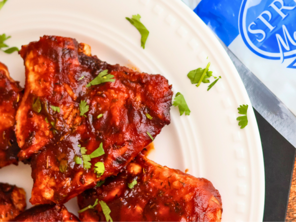 Air Fryer BBQ Chicken Breast made with Springer Mountain Farms Boneless Skinless Chicken Breasts, glazed with barbecue sauce and garnished with fresh parsley.