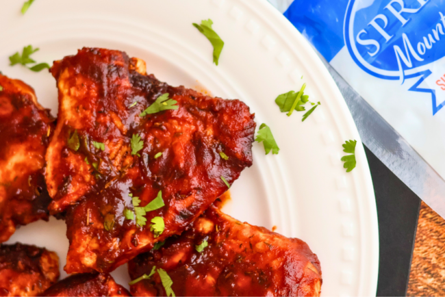 Air Fryer BBQ Chicken Breast made with Springer Mountain Farms Boneless Skinless Chicken Breasts, glazed with barbecue sauce and garnished with fresh parsley.