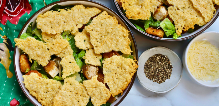 Crispy chicken Caesar salad topped with fully cooked gluten free breaded chicken strips and crunchy potatoes