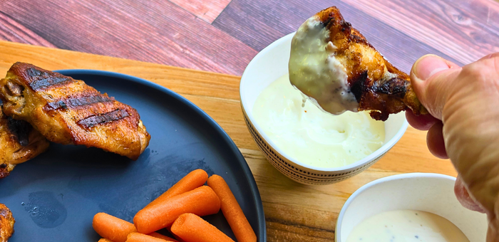 grilled chicken wing dipped in ranch dressing