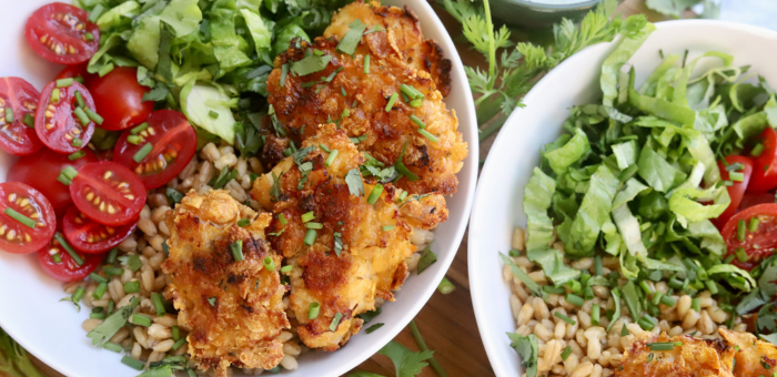 Green Goddess grain bowl with crispy chicken, barley, fresh romaine lettuce, cherry tomatoes, and creamy herb dressing.