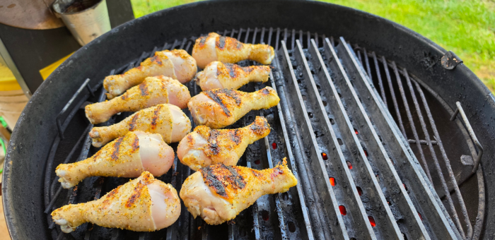 chicken drumsticks cooking over indirect heat on grill