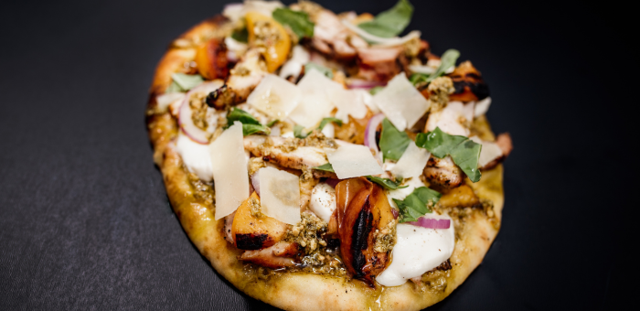 grilled chicken peach and pesto pizza topped with mozzarella fresh basil and parmesan cheese