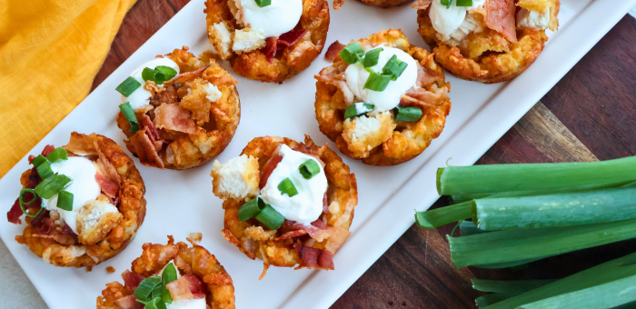 Loaded chicken bacon tater tot cups topped with crispy fully cooked gluten free breaded chicken strips and melted cheese